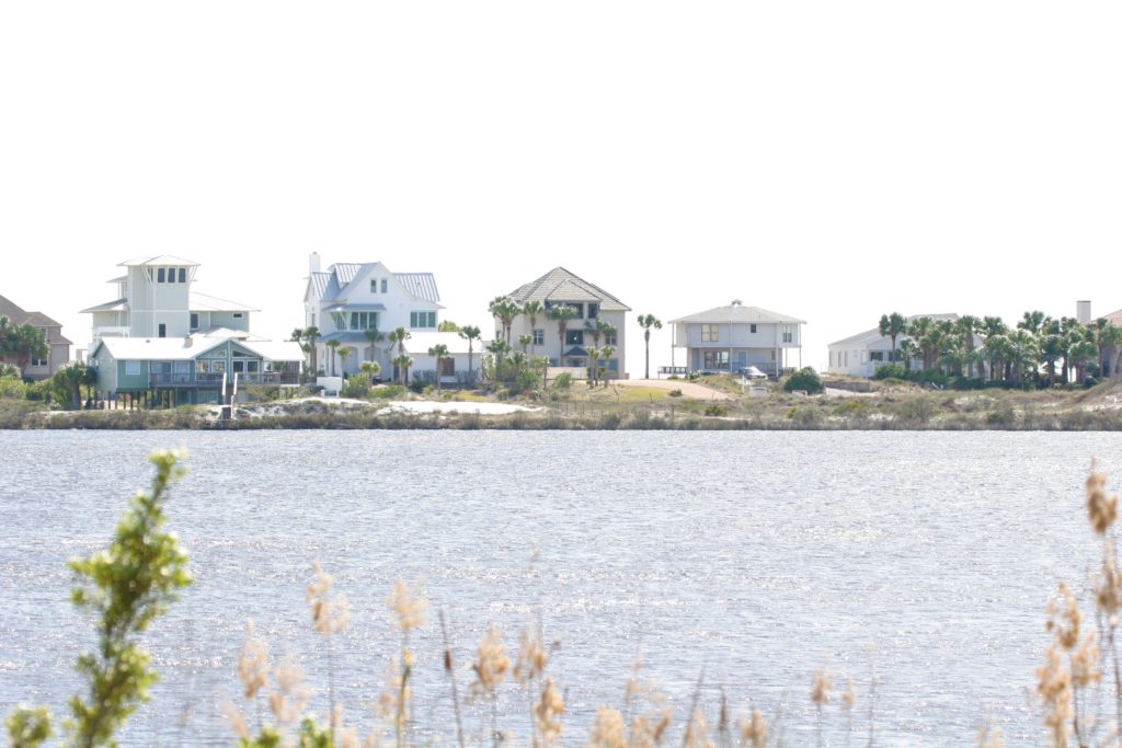 Homes viewed from across coastal dune lake